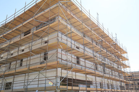Multi-storey building under construction with scaffolding (new residential complex)