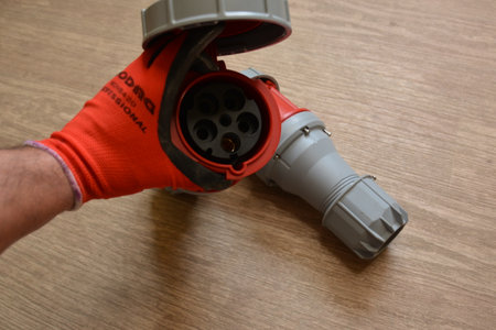 Blue plastic professional power connector. High voltage power electric cable. Industrial power plug...