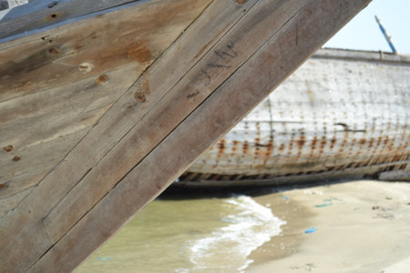 Ruined wreck of a fishing boat stranded on a sandy beach.の写真素材