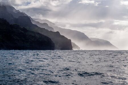 Mist arrises from the Na'Pali Coast of the Island of Kauai in Hawaii.