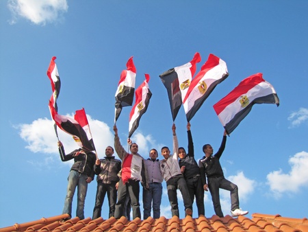 Alexandria, Egypt - February 11, 2011 - Egyptians demonstrators waving flags                               のeditorial素材