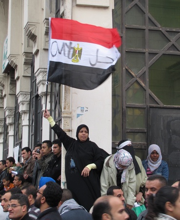 Alexandria, Egypt - February 04, 2011 - Woman waving flag calling for the resignation of President Mubarak のeditorial素材