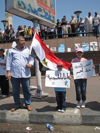 Alexandria, Egypt - July 8, 2011 - Egyptian demonstrators  calling for the prosecution of members of the former regime. Youg girl carrying 'I'm a thug' sign.のeditorial素材