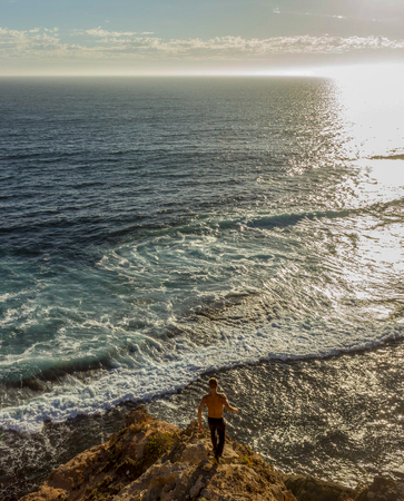 jung women standing on cliffs near port lincon at sunset, South Australia, australiaの写真素材