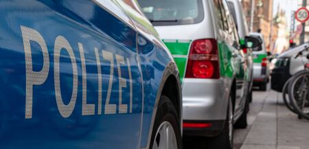 CENTRAL STATIONS, MUNICH, APRIL 6, 2019: blue and green german police car at the central station in munichのeditorial素材