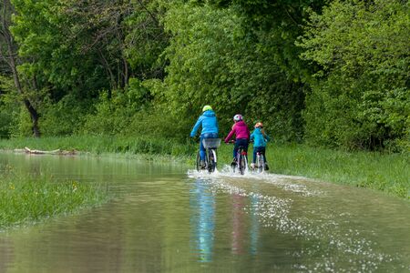 munich, isar, brudermuehlbruecke, Mai 22, 2019: storm deep axel is flooding the isar in munich, bikers trying to cross the flooedes bike waysのeditorial素材