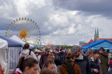 theresienwiese, munich, germany, 2019 april 27: Jumble sale flea market in bavaria at the theresienwiese in munich with a ferris wheel in the backgroundのeditorial素材