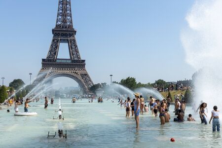 Paris, France, June 27, 2019: tourists and locals taking a bath in the Jardins du Trocad ro Guardians of the Trocadero under the powerful water cannons. new heat records over 45 degrees celiusのeditorial素材