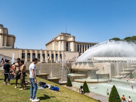 Paris, France, June 27, 2019: tourists and locals taking a bath in the Jardins du Trocad ro Guardians of the Trocadero under the powerful water cannons. new heat records over 45 degrees celiusのeditorial素材