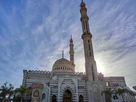 mosque with minaret lit by sunset, dahab, egyptの写真素材