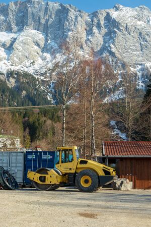 Eibsee, Germany, March 31, 2019: a large excavator on a constructions site before the tourist season...