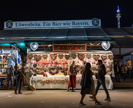 Munich, Germany - September 24: visitors, beertents and fairground rides on the oktoberfest in munich at night.のeditorial素材