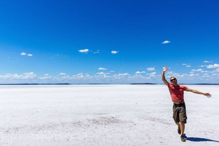 time to relax for a man walking on a salt lake in westernの写真素材