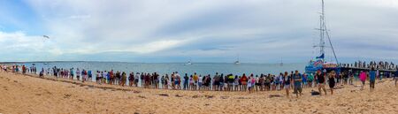Monkey Mia, Australia - April 15, 2015- line of tourists at monkey mia beach, everybody is waiting for the wild dolphins to arriveのeditorial素材
