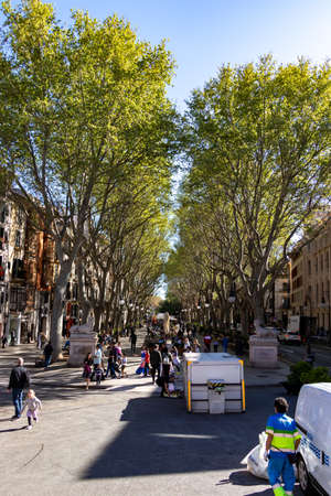 Palma, Mallorca - April 10, 2019: entrance of La Rambla with tourists and locals walking.
