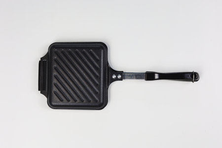 Black frying pan isolated on white background. Top view. Flat lay.の写真素材
