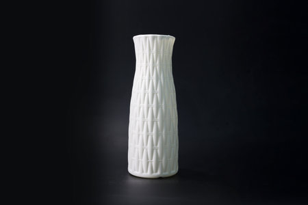 White ceramic vase on a black background. Isolated object.の写真素材