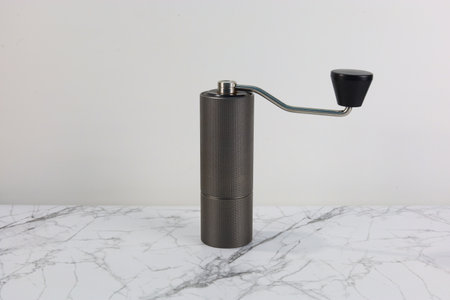 Hand crank coffee grinder on white marble patternの写真素材