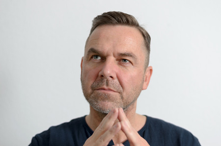 Attractive middle age man with folded handsの写真素材