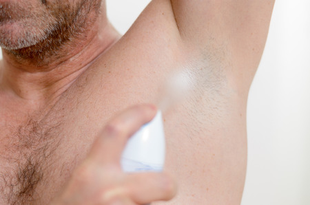 Man using a deodorant because to avoid odorの写真素材