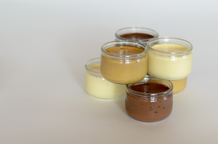 staple of six glasses of pudding, white backgroundの写真素材
