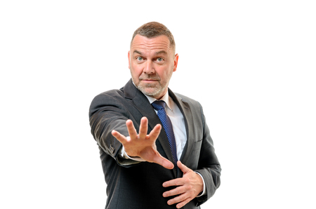 Alarmed businessman holding out his splayed hand with a wide-eyed expression as he signals enough or calls a halt, on whiteの写真素材