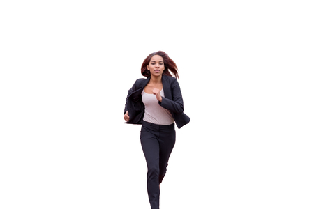 Young brunette woman in black office clothes running rapidly towards camera. Isolated on whiteの写真素材