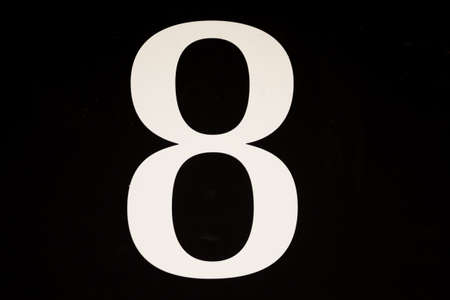 High contrast black and white sign with the stencilled number eight - 8 - in a close up full frame viewの写真素材