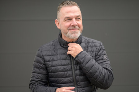 Middle age man looks aside in anticipation of something niceの写真素材