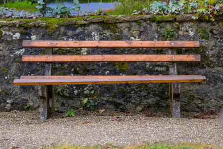 Empty wooden bench in a cemetery.