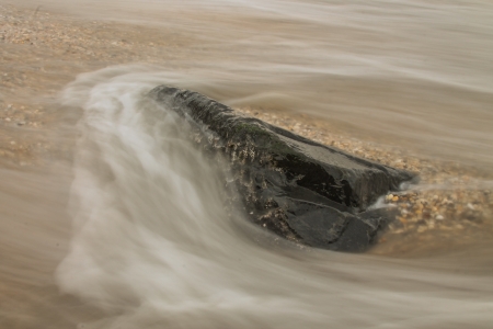 Wave falling over rock. の素材
