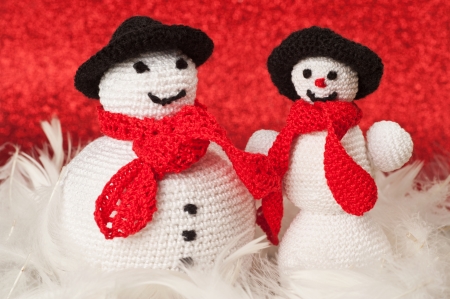 Fat and skinny crochet snowmenの写真素材