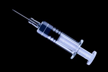 Hypodermic syringe with finer vaccine gauge needle for less pain, isolated on black backgroundの写真素材