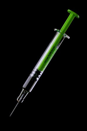Hypodermic syringe with fine vaccine gauge needle for less pain, isolated on black backgroundの写真素材