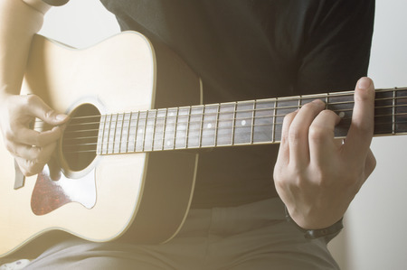 Men Playing Acoustic Guitar Closeup cord Bm with sunlightの写真素材