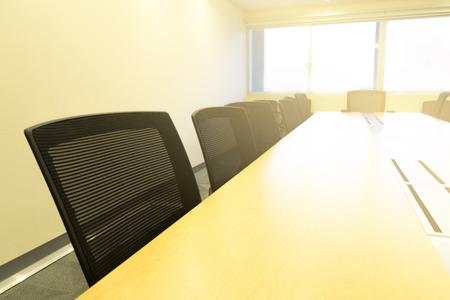 wooden table in meeting room white board sunlight from windowの写真素材