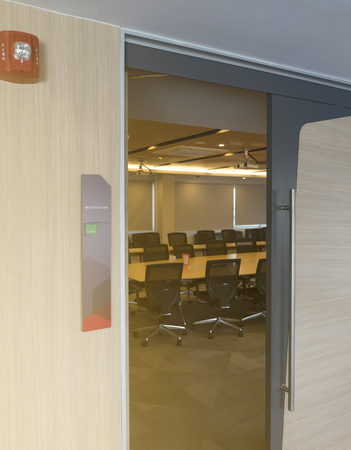 Front of meeting room with tag status vacant and Fire alarm notification wooden table sunlight from windowの写真素材