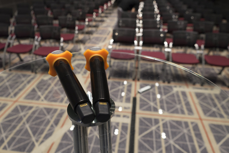 double microphone on glass table at conference hallの写真素材