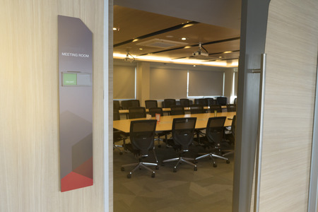 Front of meeting room with tag status vacant and Fire alarm notification wooden table sunlight from windowの写真素材