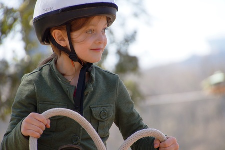 Girl holding the reigns horseback ridingの写真素材