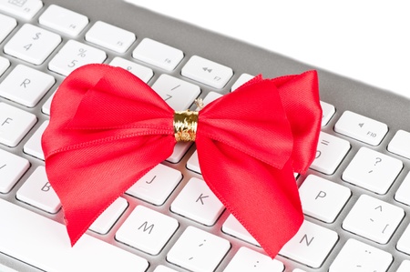Modern computer keyboard with red bright bow.の写真素材