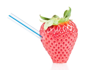 Strawberry with drinking straw over a white reflective backgroundの写真素材