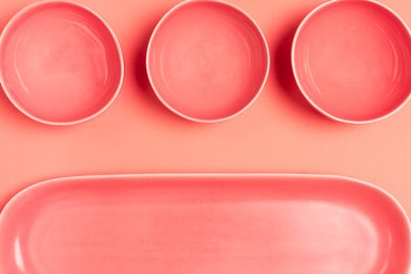 Set of colored bowls and long plate