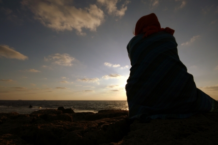 girl looking at sunsetの写真素材