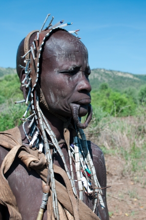 OMO VALLEY, ETHIOPIA - JAN 29  Mursi woman posing in the village,the ethnic groups in the The Omo valley Could disappear Because of Gibe III hydroelectric dam on Jan 29, 2012 in Omo Valley, Ethiopia のeditorial素材