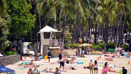 OAHU, HI - JUNE 22, 2013 - Tourist sunbathing and surfing on Waikiki beach June 22, 2013 in Oahu  Waikiki beach is beachfront neighborhood of Honolulu, best known for white sand and surfingのeditorial素材