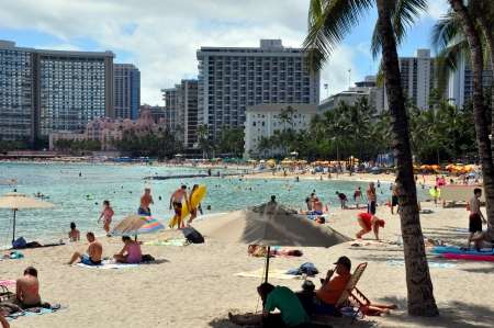 OAHU, HI - JUNE 22, 2013 - Tourist sunbathing and surfing on Waikiki beach June 22, 2013 in Oahu  Waikiki beach is beachfront neighborhood of Honolulu, best known for white sand and surfingのeditorial素材