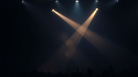 Stage lights and crowd of people at a live concert in the theater
