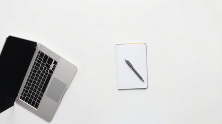 Top view of laptop, notebook and pen on white background. Flat layの写真素材