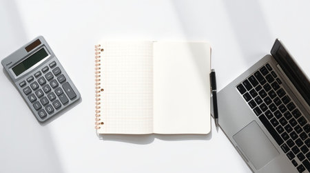 Office desk table with laptop, notebook, pen and calculator. Top view with copy spaceの写真素材